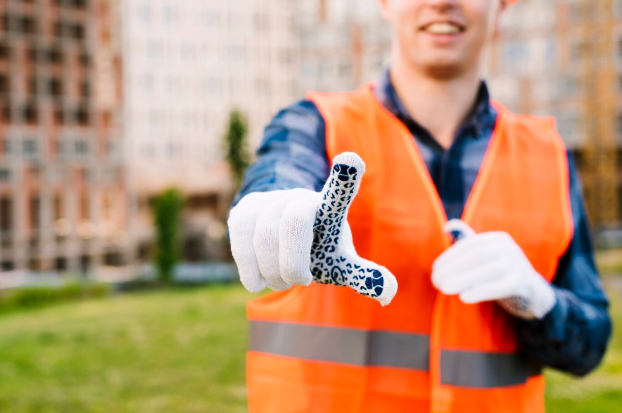 A construction worker in safety gear prepares to ensure on-site precision and safety during a project